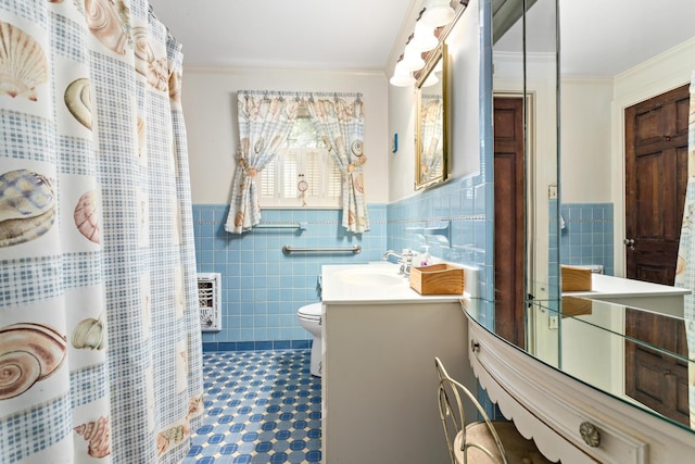 bathroom with vanity, toilet, ornamental molding, tile walls, and heating unit