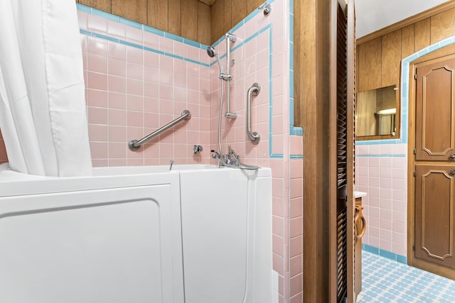 bathroom with tile walls and independent shower and bath