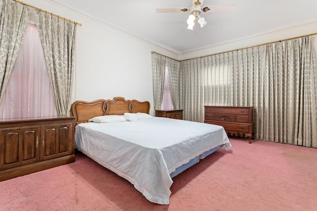 bedroom featuring carpet flooring, ceiling fan, and crown molding