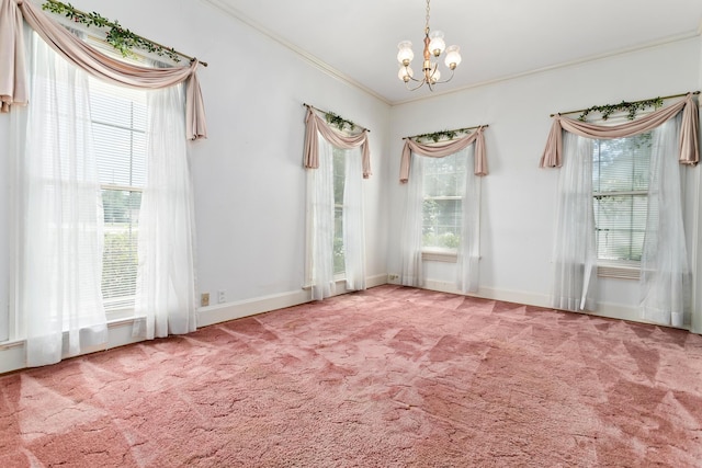 unfurnished room with crown molding, carpet floors, and an inviting chandelier