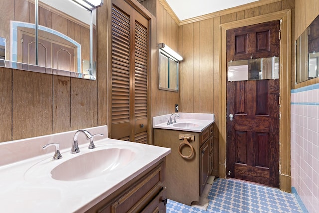 bathroom featuring vanity, wood walls, and crown molding