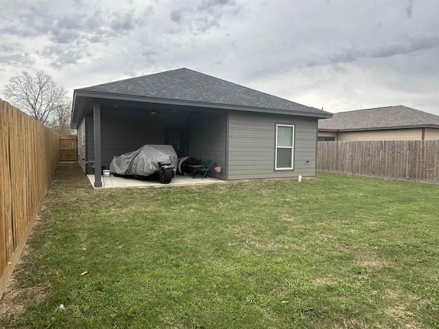 rear view of house with a yard and a patio