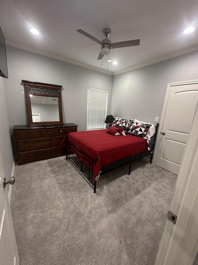 bedroom featuring ceiling fan, crown molding, and light carpet