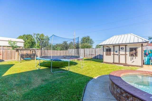 view of yard featuring a storage unit and a trampoline