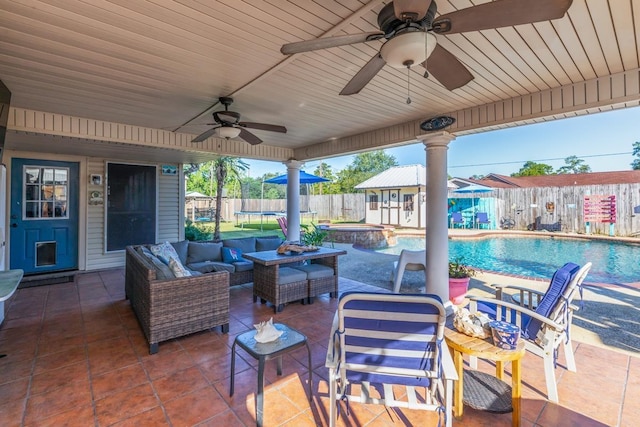 view of patio with a fenced in pool, outdoor lounge area, and ceiling fan