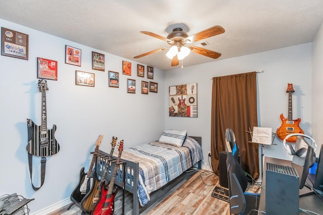 bedroom with wood-type flooring and ceiling fan