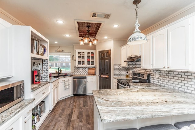 kitchen with appliances with stainless steel finishes, dark hardwood / wood-style floors, white cabinetry, and pendant lighting