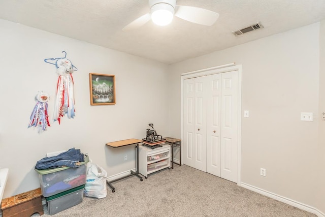 interior space with light colored carpet and ceiling fan