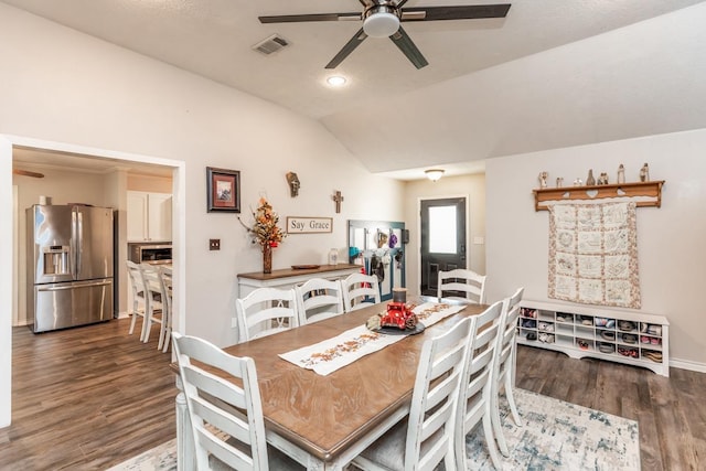 dining space featuring ceiling fan, dark wood-type flooring, and lofted ceiling