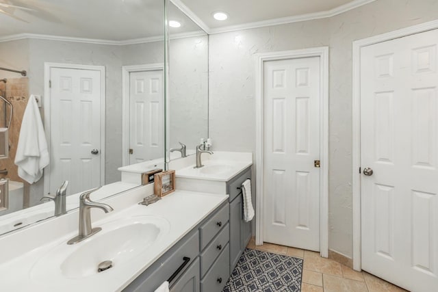 bathroom with tile patterned floors, crown molding, and vanity