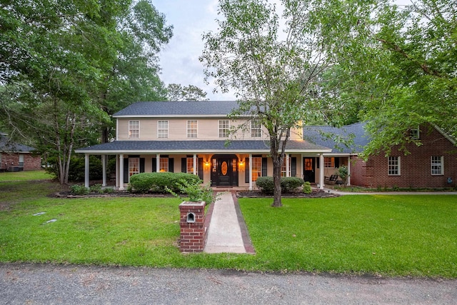415 Neches Ct, Lumberton, TX 77657 - view of front of house featuring covered porch, a front lawn, and a shingled roof