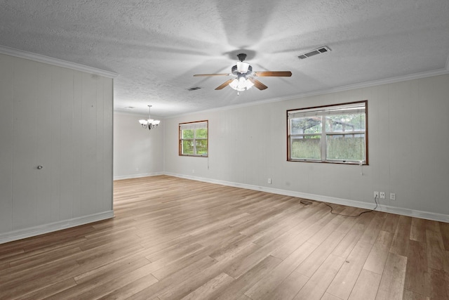 8598 Cornell Dr, Lumberton, TX 77657 - spare room with a ceiling fan, light wood finished floors, a chandelier, crown molding, and a textured ceiling