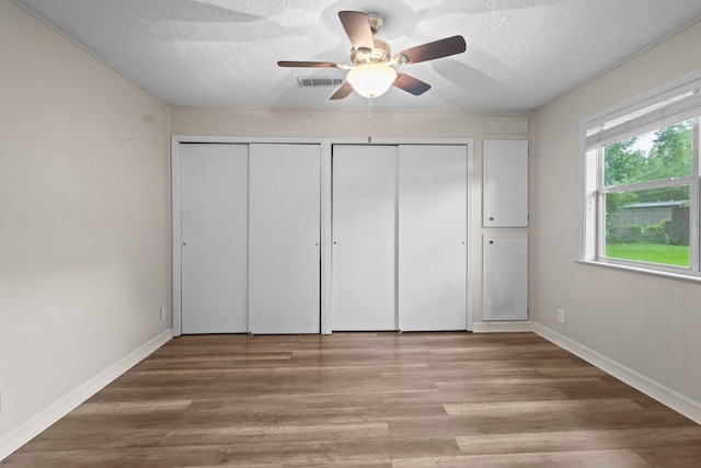 8598 Cornell Dr, Lumberton, TX 77657 - unfurnished bedroom with a textured ceiling, light wood-type flooring, and ceiling fan