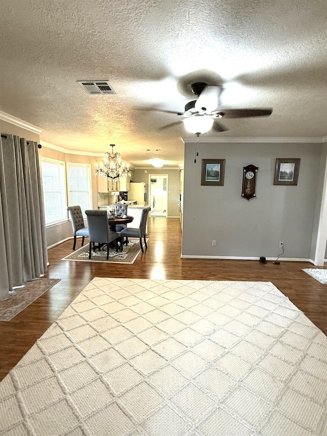 dining room with visible vents, ornamental molding, dark wood finished floors, and baseboards