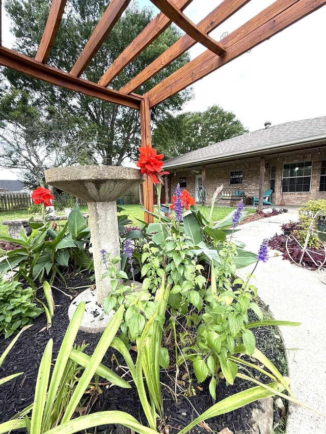 view of yard featuring a pergola and fence