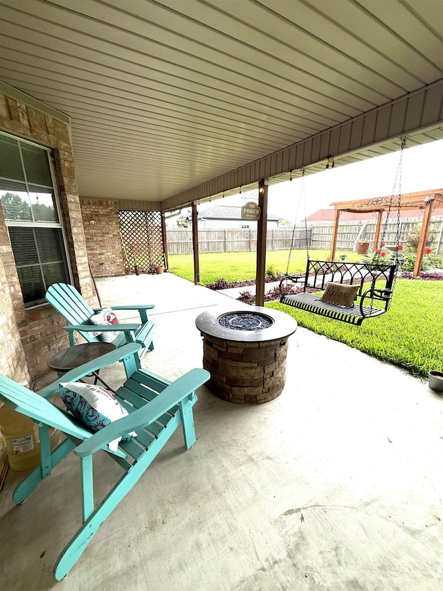 view of patio with fence and an outdoor fire pit
