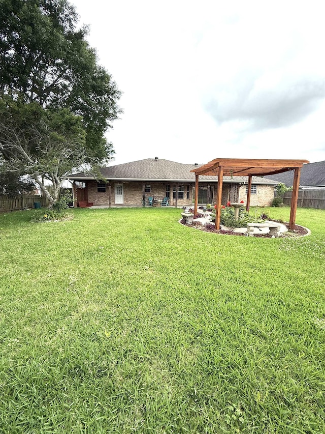 view of yard with fence and a pergola