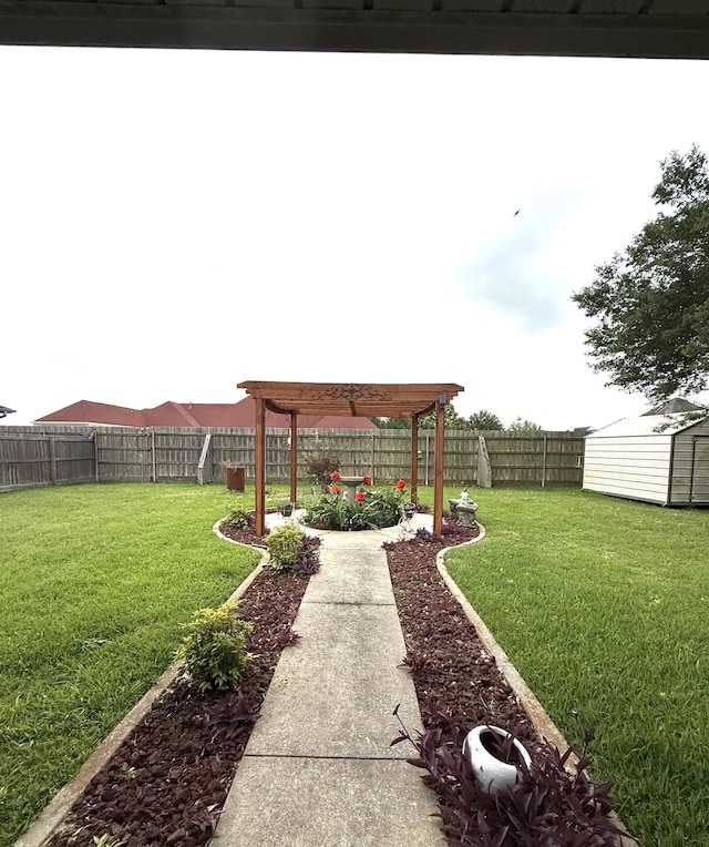 view of yard with a fenced backyard, an outbuilding, and a storage shed