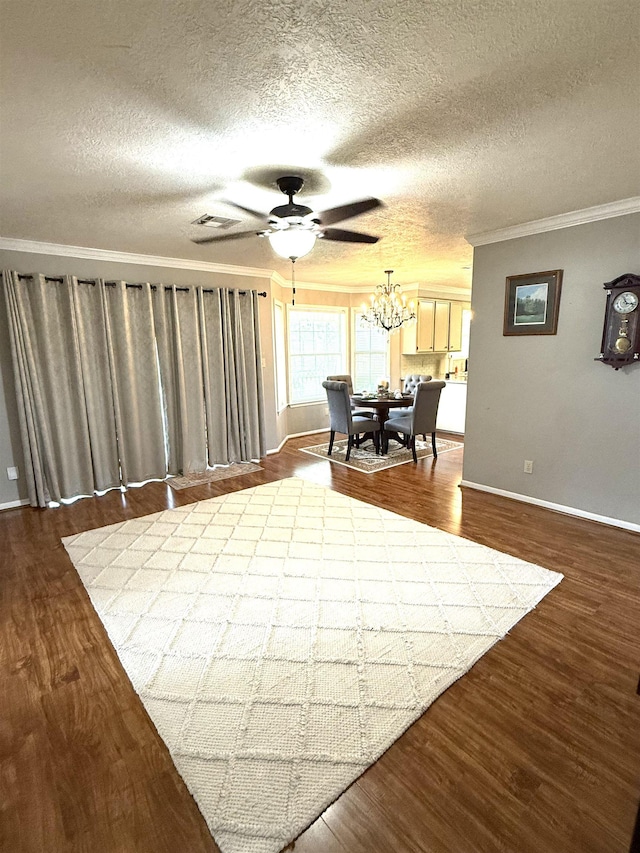 interior space featuring crown molding, baseboards, ceiling fan with notable chandelier, and dark wood-style floors