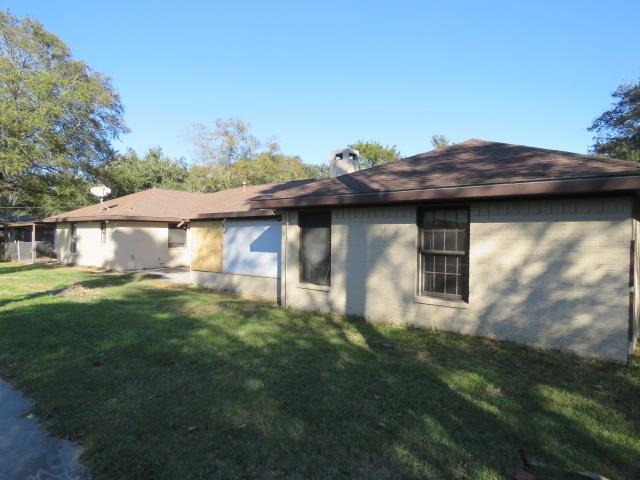 view of side of home featuring a yard