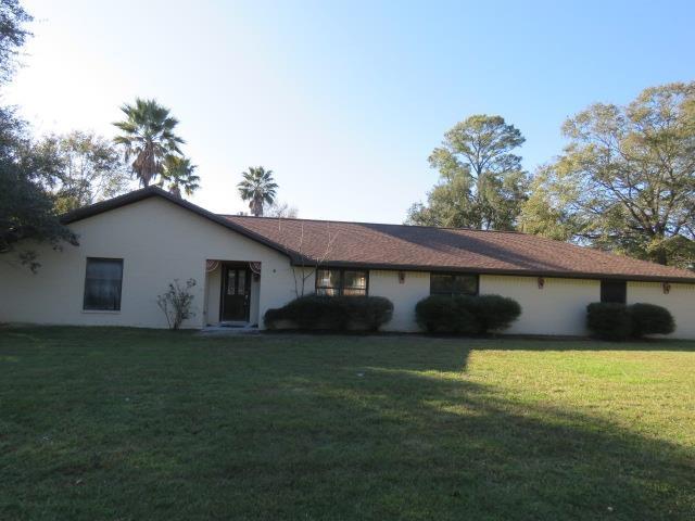 ranch-style house with a front lawn