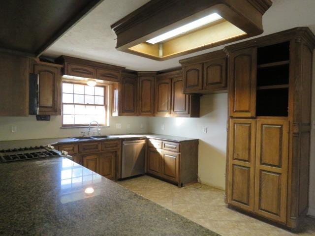 kitchen featuring dishwasher, light tile patterned floors, and sink