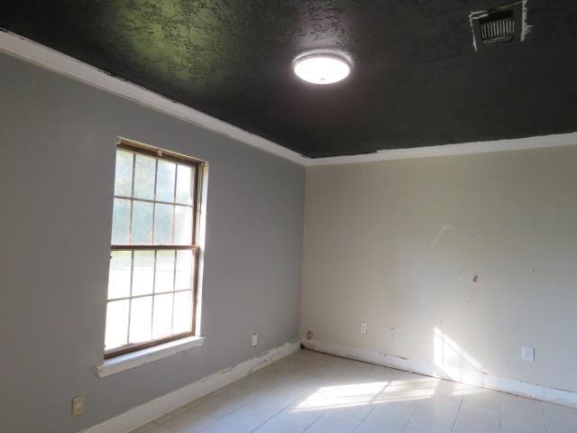 spare room featuring ornamental molding