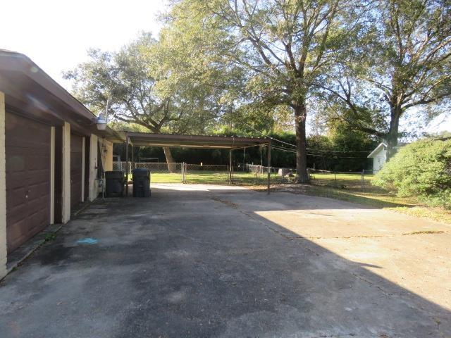 view of parking / parking lot featuring a carport