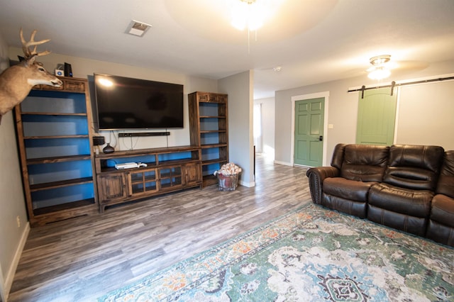 living room with hardwood / wood-style flooring and a barn door