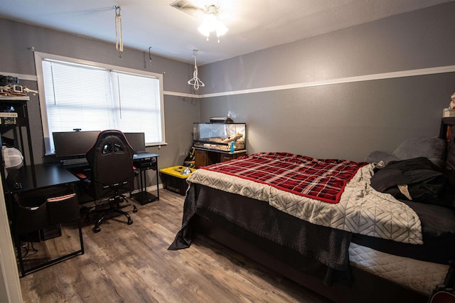 bedroom featuring hardwood / wood-style floors and ceiling fan