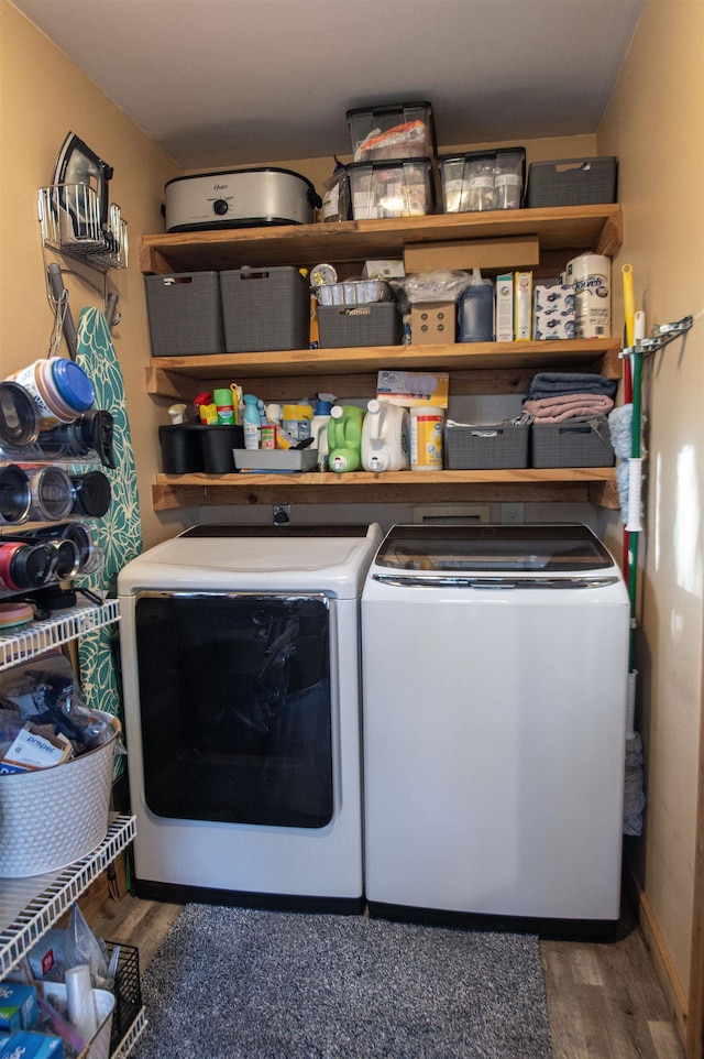 laundry room with dark hardwood / wood-style flooring and separate washer and dryer