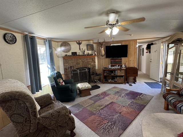 carpeted living room with lofted ceiling, a textured ceiling, wooden walls, ceiling fan, and a fireplace