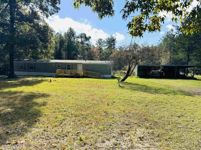 view of yard featuring a carport and a deck