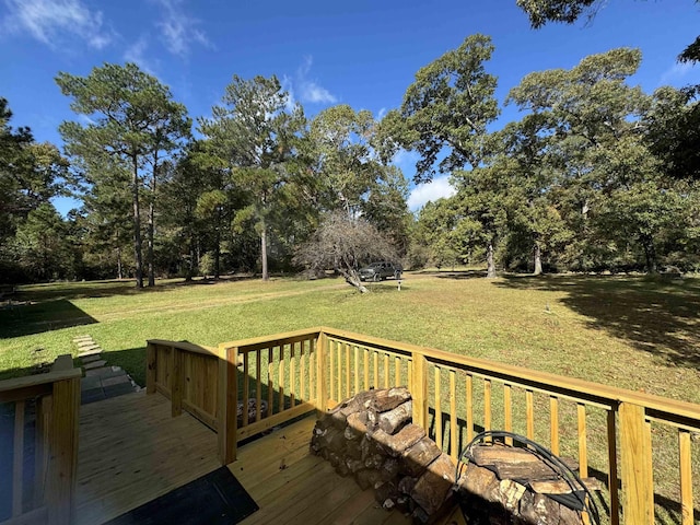 wooden deck featuring a lawn