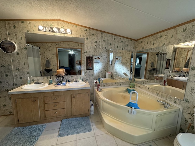 bathroom featuring lofted ceiling, vanity, crown molding, tile patterned floors, and a textured ceiling