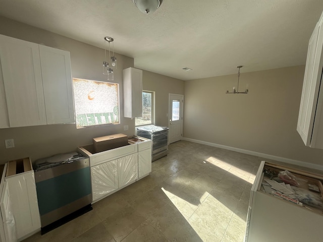 kitchen featuring white cabinetry, decorative light fixtures, and baseboards