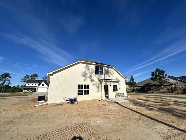 back of house featuring central air condition unit