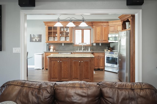 5200 N Fm 105, Vidor, TX 77662 - kitchen featuring stainless steel appliances, dark wood-style floors, a kitchen island, backsplash, and a sink