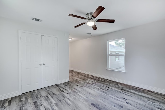 unfurnished bedroom featuring a closet, ceiling fan, and light hardwood / wood-style floors