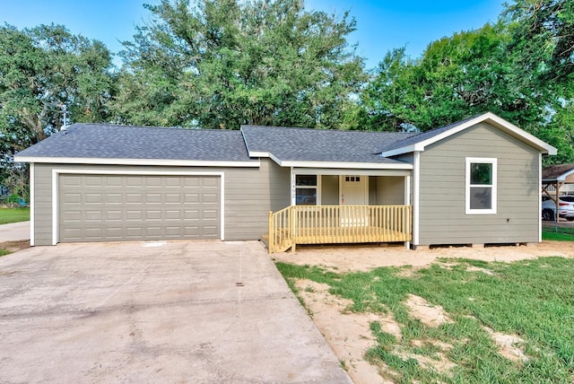 single story home featuring covered porch and a garage