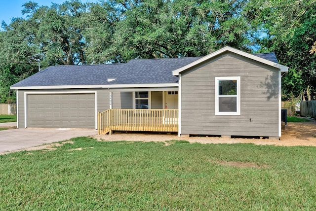 ranch-style house featuring covered porch, a garage, and a front yard