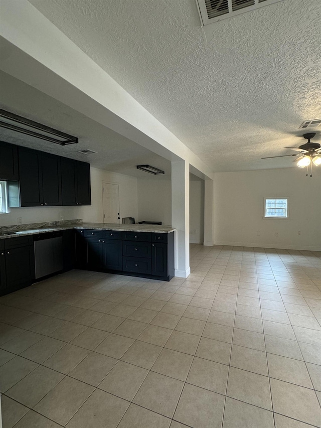 kitchen featuring stainless steel dishwasher, ceiling fan, and light tile patterned flooring