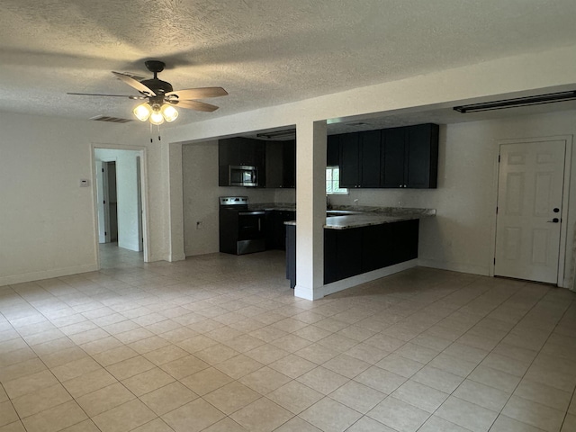 unfurnished living room featuring a textured ceiling and ceiling fan