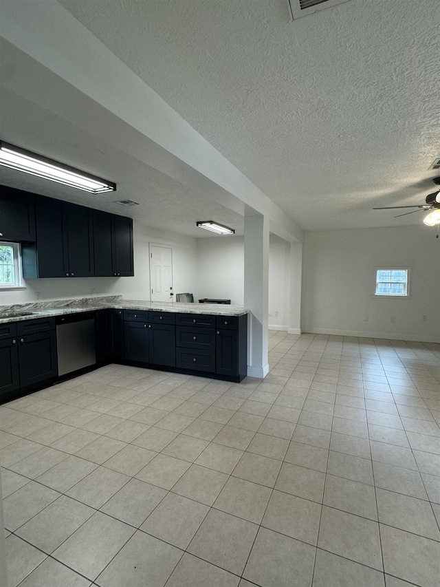 kitchen featuring ceiling fan, dishwasher, light tile patterned floors, and plenty of natural light