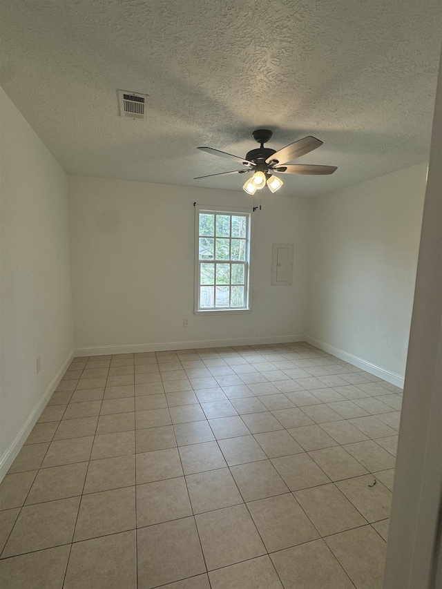 spare room featuring ceiling fan and light tile patterned floors