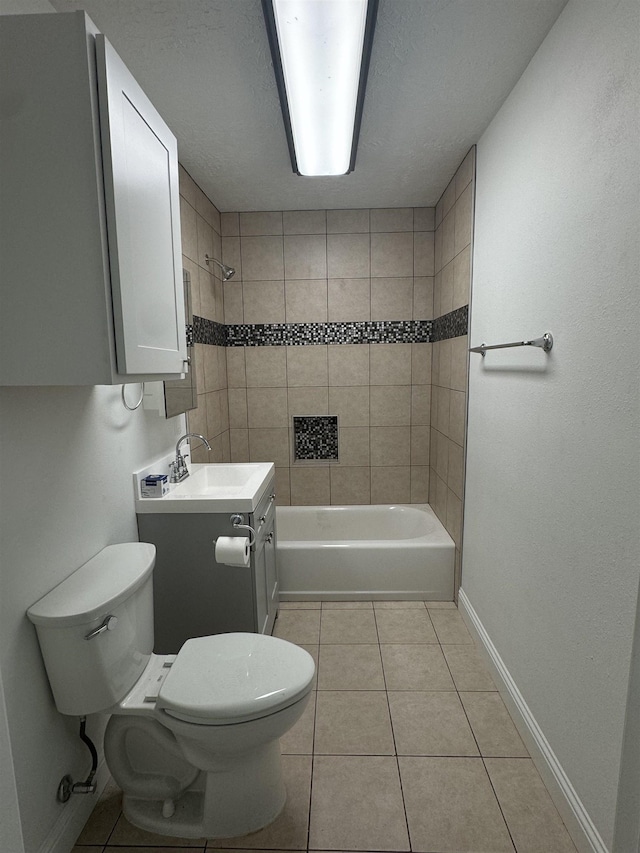 full bathroom featuring tile patterned floors, vanity, toilet, and tiled shower / bath combo