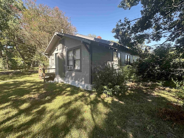 view of side of home featuring a yard and cooling unit