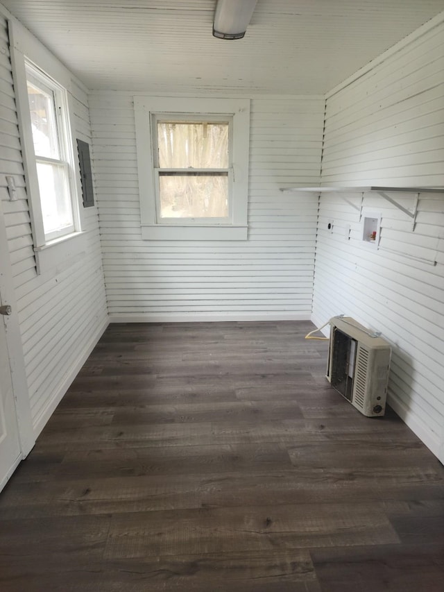 washroom with washer hookup, dark hardwood / wood-style floors, wood walls, and an AC wall unit