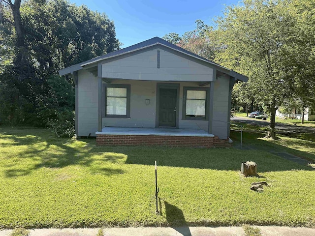 bungalow-style home featuring a porch and a front yard