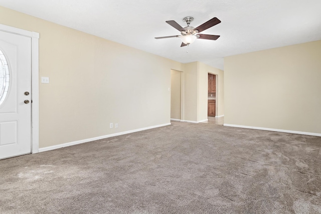 empty room featuring carpet floors and ceiling fan